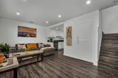 a living room with a couch and a table at Modern 2 Levels One-Bedroom Retreat in central Location in Hollywood in Los Angeles