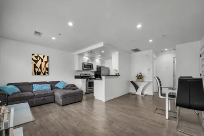 a living room with a couch and a kitchen at Fully Furnished 1 Bedroom Apartment with Full Bathroom in Koreatown Free Gated Parking Full Kitchen in Los Angeles