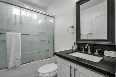 a bathroom with a toilet and a sink and a mirror at Fully Furnished 1 Bedroom Apartment with Full Bathroom in Koreatown Free Gated Parking Full Kitchen in Los Angeles