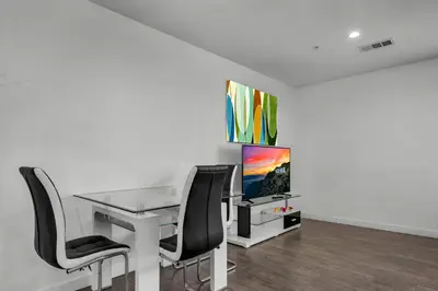 an office with a desk and chairs and a tv at Fully Furnished 1 Bedroom Apartment with Full Bathroom in Koreatown Free Gated Parking Full Kitchen in Los Angeles