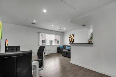 a living room with a couch and a table at Fully Furnished 1 Bedroom Apartment with Full Bathroom in Koreatown Free Gated Parking Full Kitchen in Los Angeles