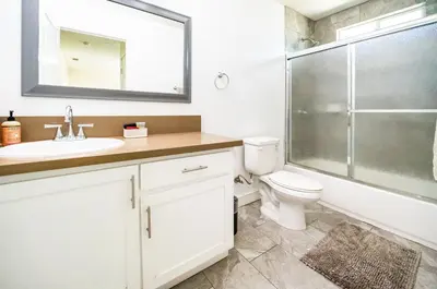 a bathroom with a toilet and a sink and a shower at Spacious 5 Bedroom 3 Bath Home for Large Groups By DT LA in Los Angeles