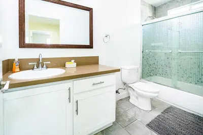 a bathroom with a sink and a toilet and a shower at Spacious 5 Bedroom 3 Bath Home for Large Groups By DT LA in Los Angeles