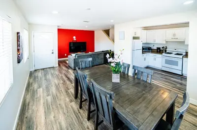 a kitchen and dining room with a wooden table and chairs at Spacious 5 Bedroom 3 Bath Home for Large Groups By DT LA in Los Angeles