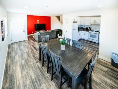 a dining room and kitchen with a wooden table and chairs at Spacious 5 Bedroom 3 Bath Home for Large Groups By DT LA in Los Angeles