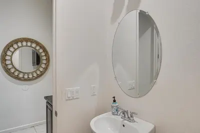 a bathroom with a sink and a mirror at Rio Bravo Country Club Home in Bakersfield with Pool in Bakersfield