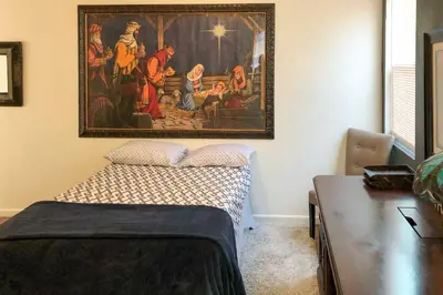 a bedroom with a painting hanging on the wall at Rio Bravo Country Club Home in Bakersfield with Pool in Bakersfield