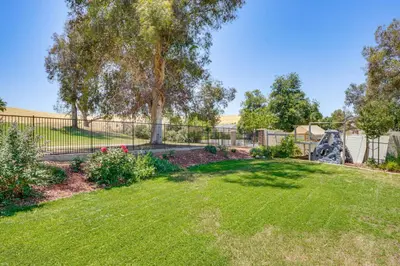 a yard with a fence and a playground at Rio Bravo Country Club Home in Bakersfield with Pool in Bakersfield