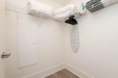 a room with a white wall with a shelf at The Modern Suite Residences in Glendale