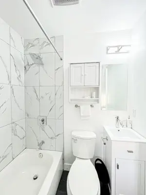 a white bathroom with a toilet and a sink at Elegant 4-Bedroom Family Home - Oak2 - LAD in Los Angeles