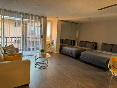 a living room with two beds and a couch at Loft & Two Bedroom Hollywood apartments FREE Parking in Los Angeles