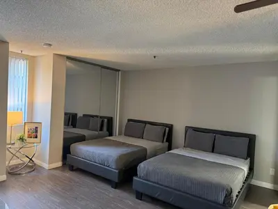 a bedroom with two beds and a mirror at Loft & Two Bedroom Hollywood apartments FREE Parking in Los Angeles