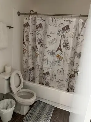 a bathroom with a toilet and a shower curtain at Loft & Two Bedroom Hollywood apartments FREE Parking in Los Angeles