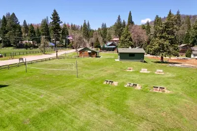 a park with benches in the middle of a field at Timberline Retreat CN Lodge #3 in Ponderosa