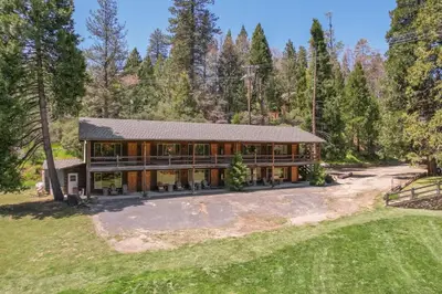 an aerial view of a large house with trees at Mountain Nook CN Lodge #4 in Ponderosa