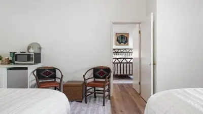 a bedroom with two chairs and a kitchen with a microwave at Sierra Vista @CN Lodge #8 in Ponderosa