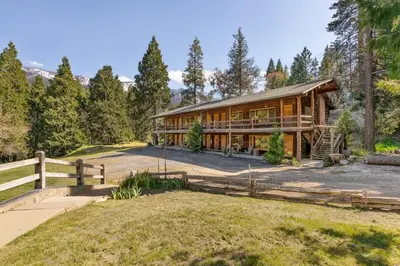 a home in the woods with a fence at Sierra Vista @CN Lodge #8 in Ponderosa