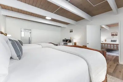 a bedroom with two white beds in a room at Bear's Den @CN Lodge #5 in Ponderosa