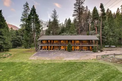 a large house in the middle of a field at Camp Nelson Lodge Room 9 in Ponderosa
