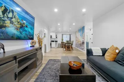 a living room with a couch and a large painting on the wall at Casa Lanzit - 35 Percent Off All March! in Los Angeles