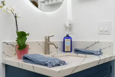 a bathroom sink with a bottle of soap on it at Casa Lanzit - 35 Percent Off All March! in Los Angeles