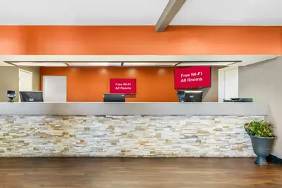 a reception counter in a hospital with two signs at Red Roof Inn Ridgecrest in Ridgecrest