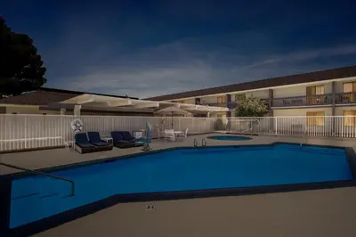 a swimming pool in front of a hotel at Red Roof Inn Ridgecrest in Ridgecrest