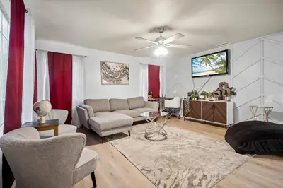 a living room with a couch and a table at Cozy single story 2 bdrm family home near the BLVD in Lancaster