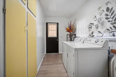 a kitchen with a white sink and a washer at Cozy single story 2 bdrm family home near the BLVD in Lancaster
