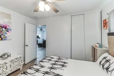a bedroom with a bed and a ceiling fan at Modern City Ranch 3 bdrm Family Home Access by Dirt Road in Palmdale