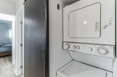 a kitchen with a washer and dryer in a room at Modern City Ranch 3 bdrm Family Home Access by Dirt Road in Palmdale