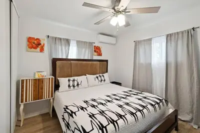 a bedroom with a bed and a ceiling fan at Modern City Ranch 3 bdrm Family Home Access by Dirt Road in Palmdale