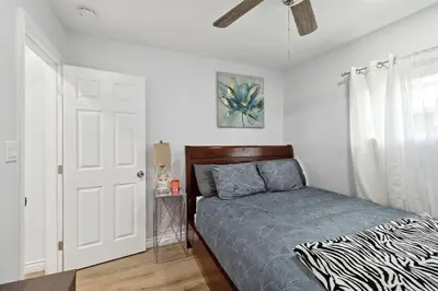 a bedroom with a bed and a white door at Modern City Ranch 3 bdrm Family Home Access by Dirt Road in Palmdale
