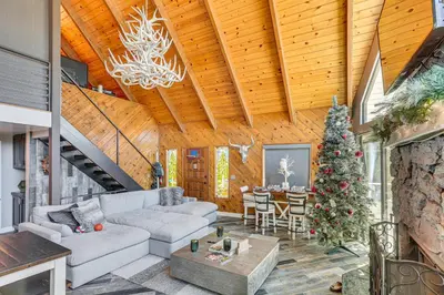 a living room with a christmas tree and a couch at Lake Arrowhead Cabin with Hot Tub and Mountain Views! in Lake Arrowhead