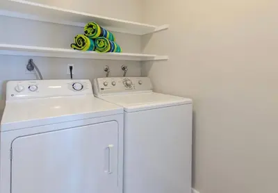 a white kitchen with a sink and a dishwasher at OCEAN PARADISE SANTA MONICA ADJACENT 2 Bedroom in Malibu