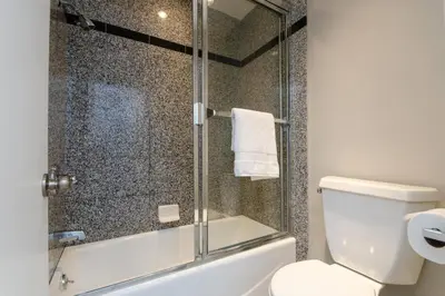 a bathroom with a toilet and a glass shower at SURF-N-SAND 2-Bedrooms, MALIBU in Malibu