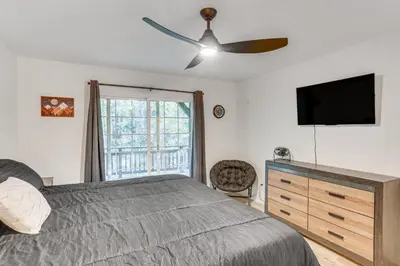 a bedroom with a bed and a ceiling fan at Crestline Home with Deck Less Than 2 Mi to Lake Gregory! in Crestline