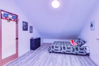 a bedroom with a bed and a basketball hoop at Crestline Home with Deck Less Than 2 Mi to Lake Gregory! in Crestline