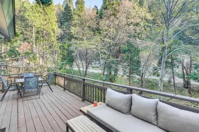 a porch with a couch and a table on a deck at Crestline Home with Deck Less Than 2 Mi to Lake Gregory! in Crestline