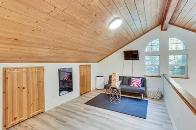 a living room with a couch and a window at Crestline Home with Deck Less Than 2 Mi to Lake Gregory! in Crestline