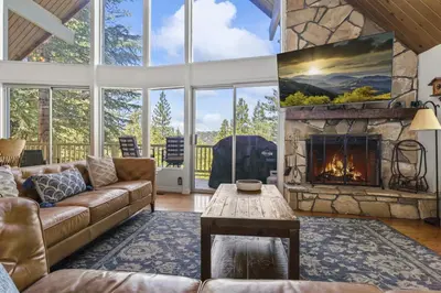 a living room with a couch and a fireplace at Luxe Mountain Retreat Lake Village Close Game Room AC Backs up to trails in Lake Arrowhead