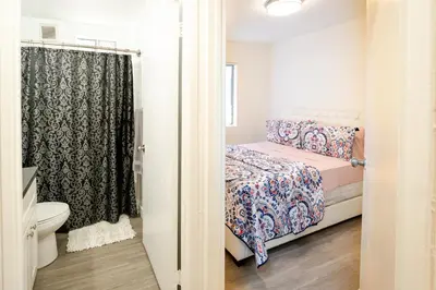 a small bedroom with a bed and a toilet at Cozy 2 Bedroom 1 Bathroom Apartment Ideal for Small Group in Koreatown Free Gated Parking Full Kitch in Los Angeles