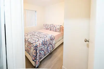 a small bedroom with a bed in a room at Cozy 2 Bedroom 1 Bathroom Apartment Ideal for Small Group in Koreatown Free Gated Parking Full Kitch in Los Angeles