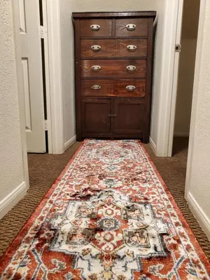 a room with a dresser and a rug on the floor at The Treetop Terrace at The Historic Arrowhead Lodge in Twin Peaks