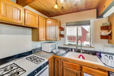 a kitchen with a stove and a sink at Frazier Park Cabin with Ping-Pong Table, Near Trails in Frazier Park