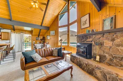 a living room with a couch and a fireplace at Frazier Park Cabin with Ping-Pong Table, Near Trails in Frazier Park
