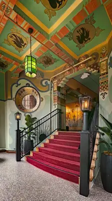 a staircase in a building with a red carpet at The Nirvana Apartment Hotel in Los Angeles