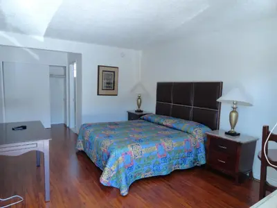 a bedroom with a bed and a wooden floor at Travel Inn in North Hills