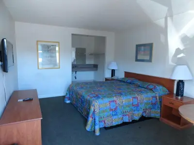 a hotel room with a bed and a table at Travel Inn in North Hills