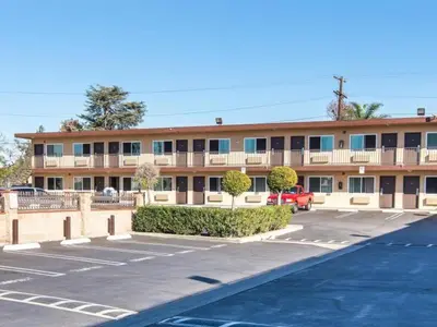 an empty parking lot in front of a building at Sea Rock Inn - Los Angeles in Los Angeles